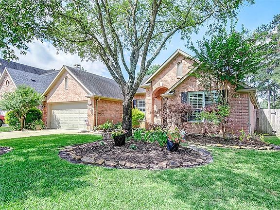 This all brick home has been immaculately cared for. This picture was taken before the flowers were in full bloom. Notice the double wide driveway and sidewalk to the covered front door. New outdoor lights keep the pathways well lit and the sprinkler