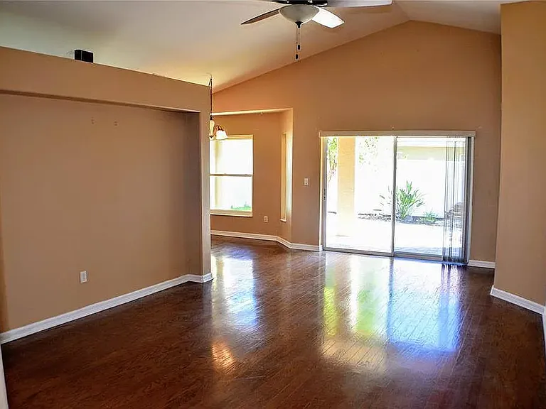 High ceiling living room with shinny wood floor