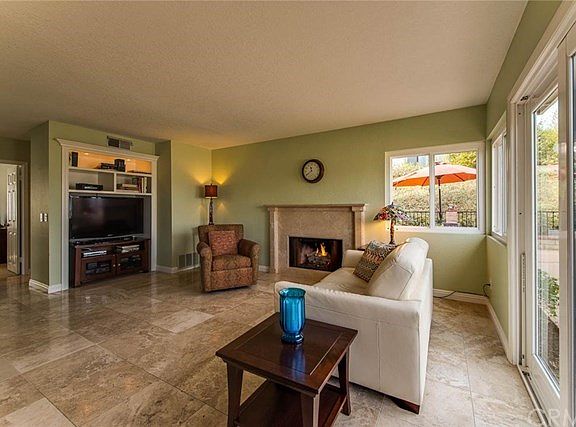 Family Room has travertine tile floors and built-in entertainment area