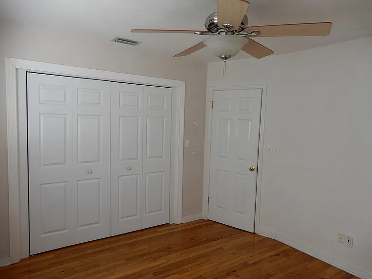 Bedroom #2 with wall to wall custom closet system.