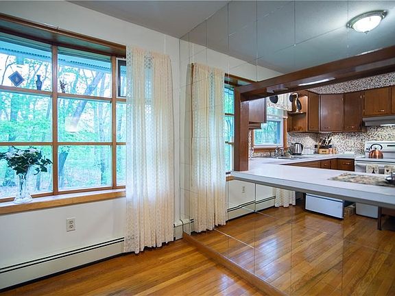Formal dining room with look through to the kitchen. Bay window overlooking the beautiful yard.