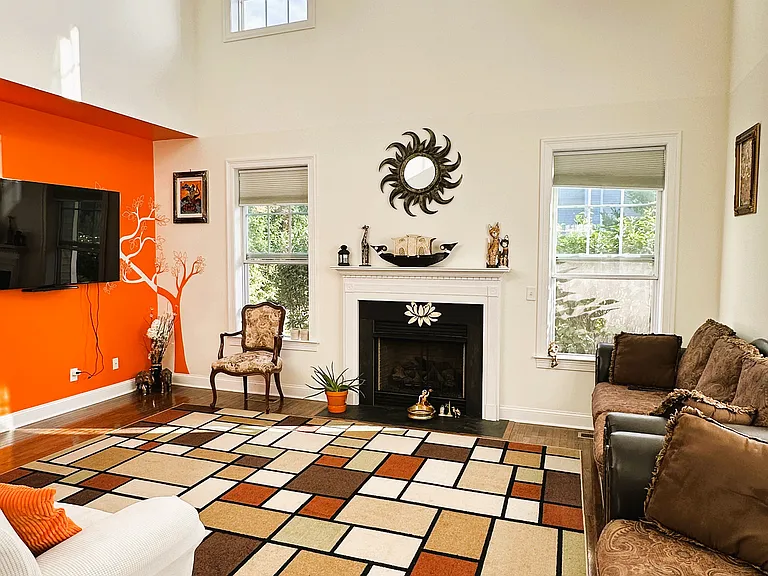 Living area with high ceiling and fire place