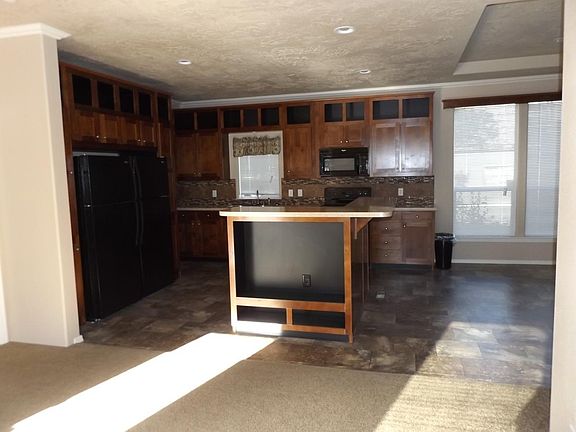 Entry to kitchen, island has additional TV space, entertainm