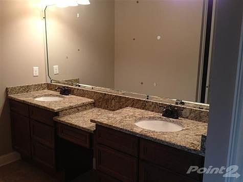 Master bath has double bowl vanities, granite countertops and undermount sinks.