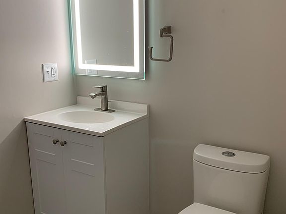 updated half bath; illuminated mirror; washer/dryer in unit