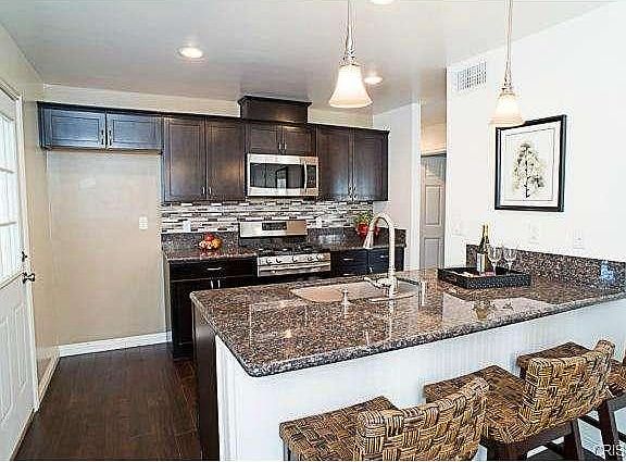 The gorgeous kitchen offers granite counter tops, custom back sp