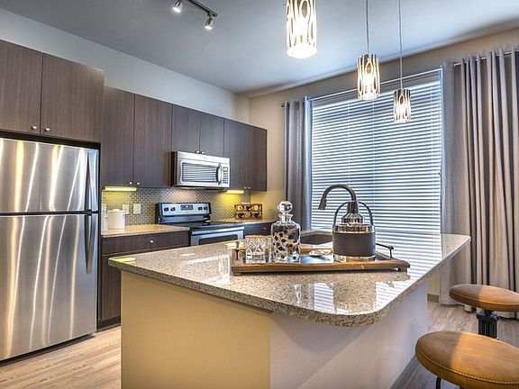 Modern lighting, breakfast bars and custom cabinetry
