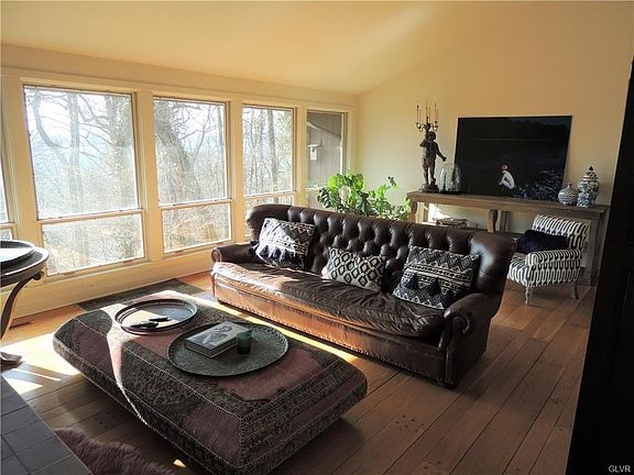 Main Living room with Cathedral ceiling and see through fireplace, wall of windows with south east exposure.