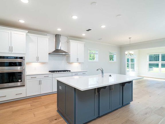 Gourmet Kitchen with Large Island, Double Wall Oven, Range Cooktop and Range Hood.