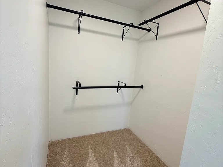 Primary bedroom walk in closet