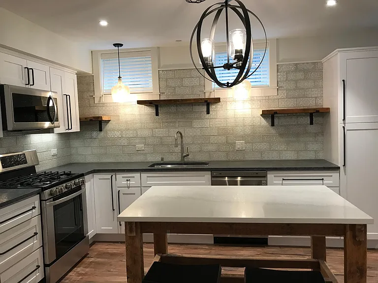 Kitchen with movable island, roll-out shelves in pantry cabinet, granite countertops, all new appliances