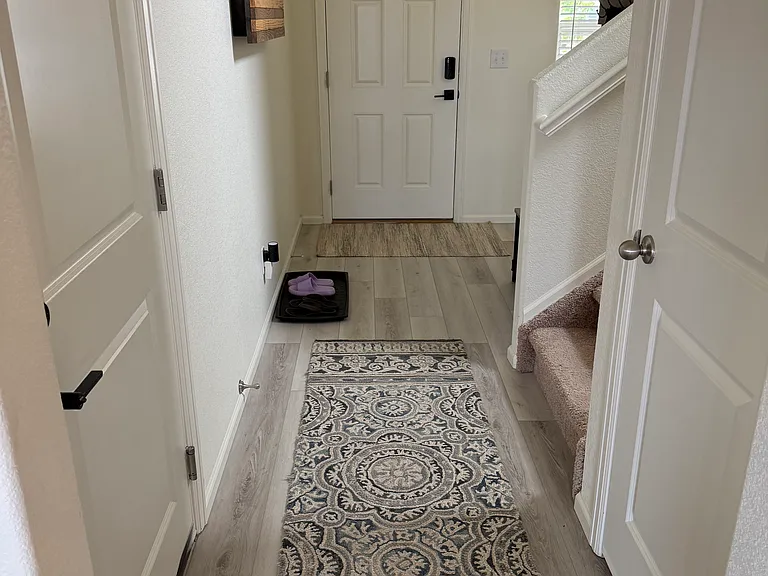 Hallway; garage access on left, storage on right
