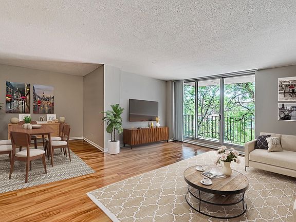 Large open living room opening up to a spacious balcony.