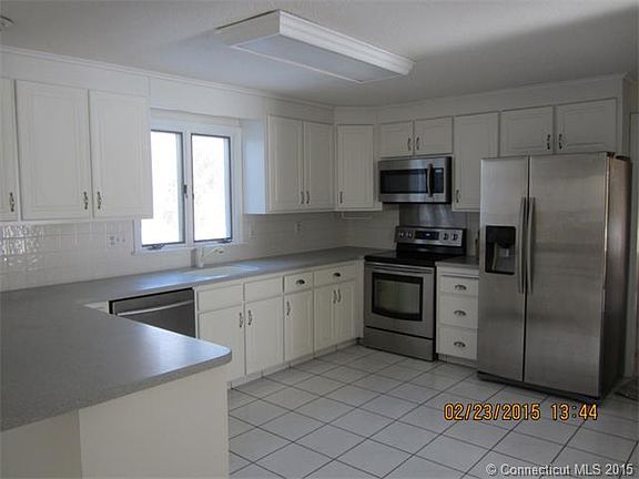 large kitchen with corian c...