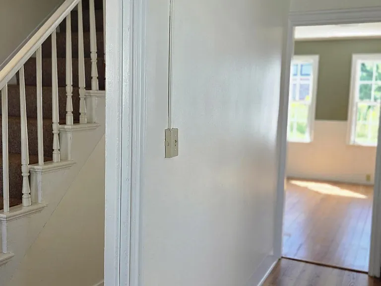 View Of Fresh Paint & New Flooring Leading From Front Entrance to Living and Dining Area
