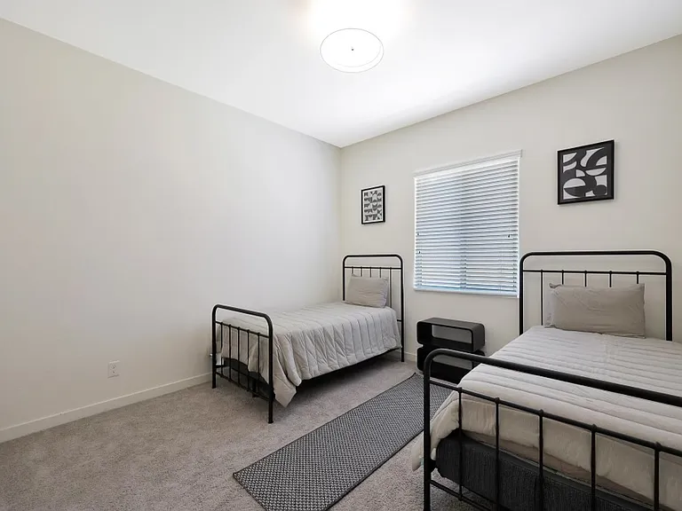 Twin beds.

Not pictured: 3rd bedroom inside of main house. Currently being used for storage. Will have a full size bed and walk-in closet.