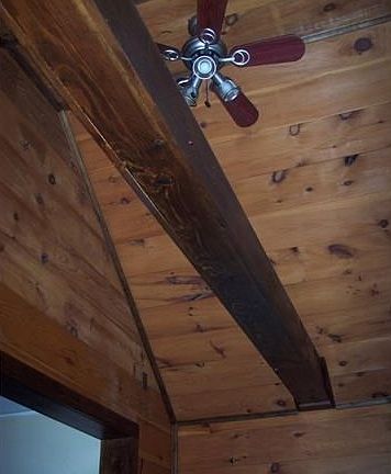 Entry vaulted ceiling with ceiling fan.