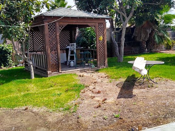 large fenced yard with gazebo