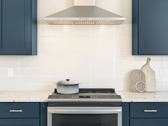 Kitchen with 3 x 12 white subway tile backsplash and chrome hood
