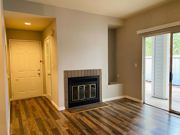 Entry way and living room with wood burning fireplace, high ceilings throughout