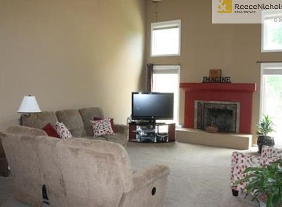 Large windows and fireplace create a focal wall