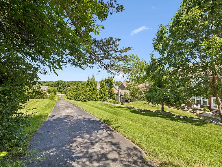 Enjoy direct access to the neighborhood walking trail from your backyard, offering a peaceful setting for morning walks, evening strolls, and outdoor recreation amid serene wooded surroundings.