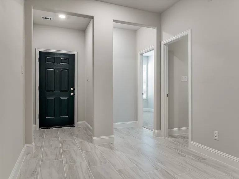Entryway featuring a dark paneled door, recessed lighting, and light gray wall paint