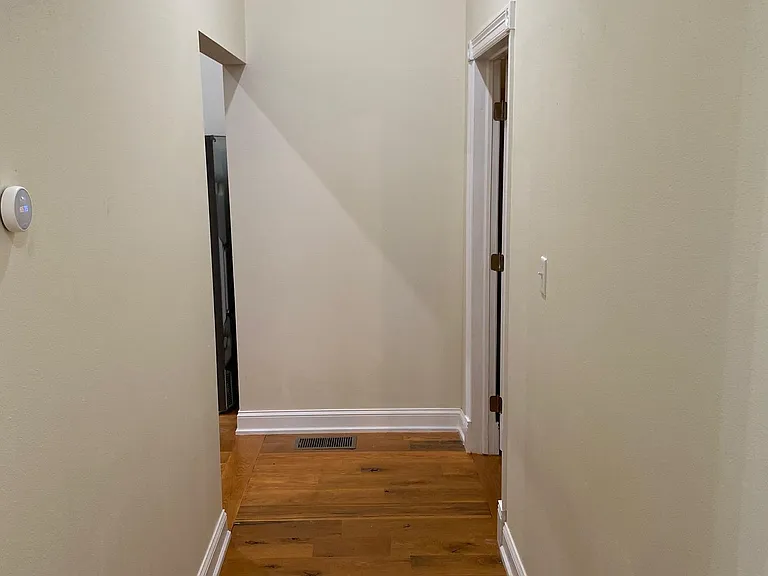 Looking down the hall towards the second bedroom (right) and kitchen (left)