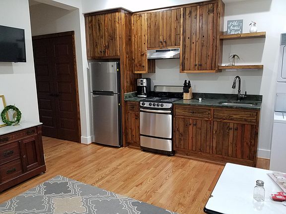 Custom cabinetry, hardwood floors, Granite counters, washer/dryer stack unit. Closet in hallway.