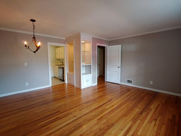 Come in the door and enter into this main room that has built-in storage area. Left door enters into the kitchen and the door to the right goes to the hallway where the bathroom and bedrooms are located.