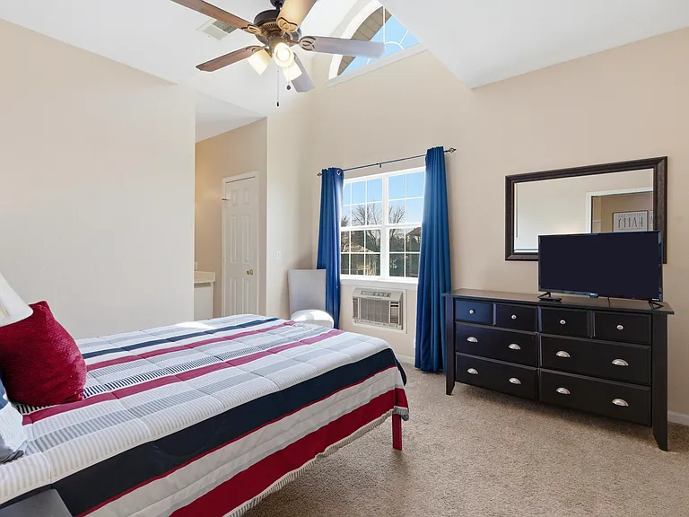 Spare bedroom fully furnished with ceiling fan and smart tv