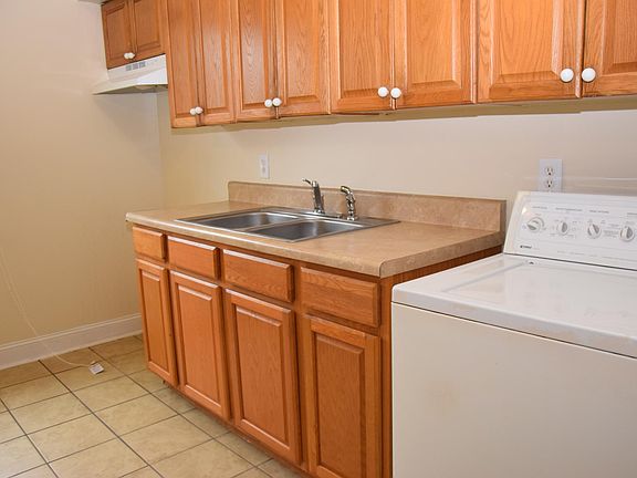Kitchen with stove, refrigerator, washer and dryer