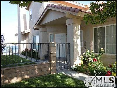 Enterance Door behind wrought iron gate.