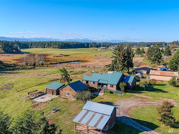 Great over view of the house and out buildings to the view of the Olympics and pond and pasture.