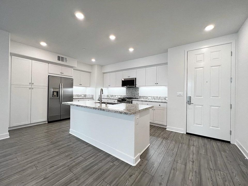 Kitchen with white shaker cabinets and upgraded flooring. Refrigerator is included in the lease. Everything is brand new.