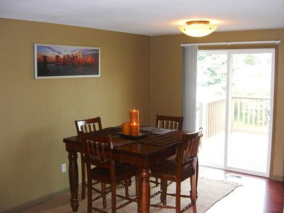 Dining room area with glass slider to deck that is perfect for entertaining.