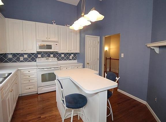 Spacious kitchen complete with all white appliances and 42 inch cabinets.