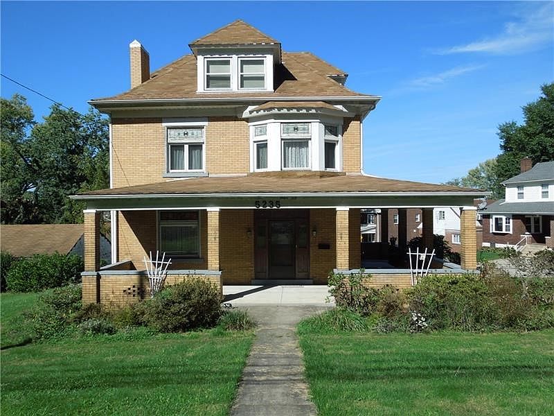Large all brick farmhouse with covered wrap around porch