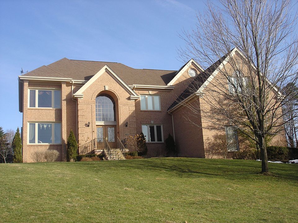 Provincial style 5 bedroom, 4.5 bath home on private one acre lot.