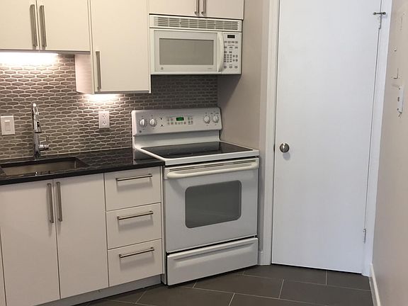 Kitchen has full size appliances and under cabinet lighting
