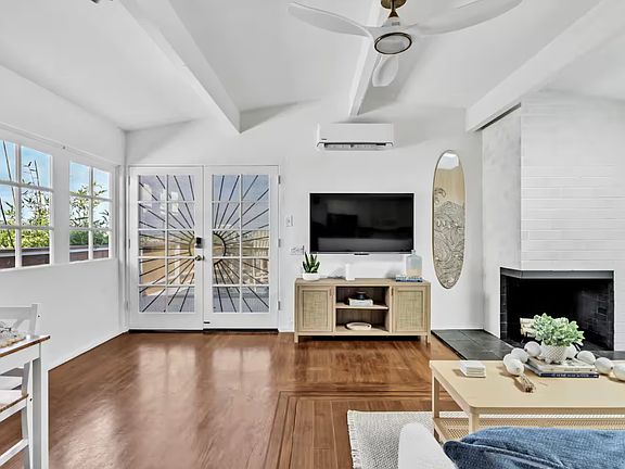 Cozy living room with a TV and a lovely fireplace