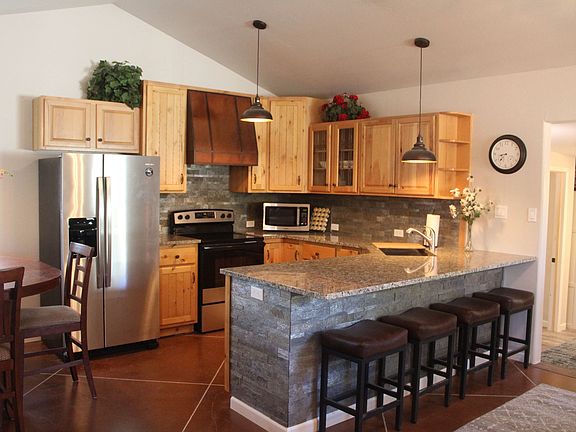 Full scale kitchen. Dishwasher, microwave, Keurig coffee maker, Amana refrigerator with ice maker & filtered well water in door. Electric stove & granite countertop.