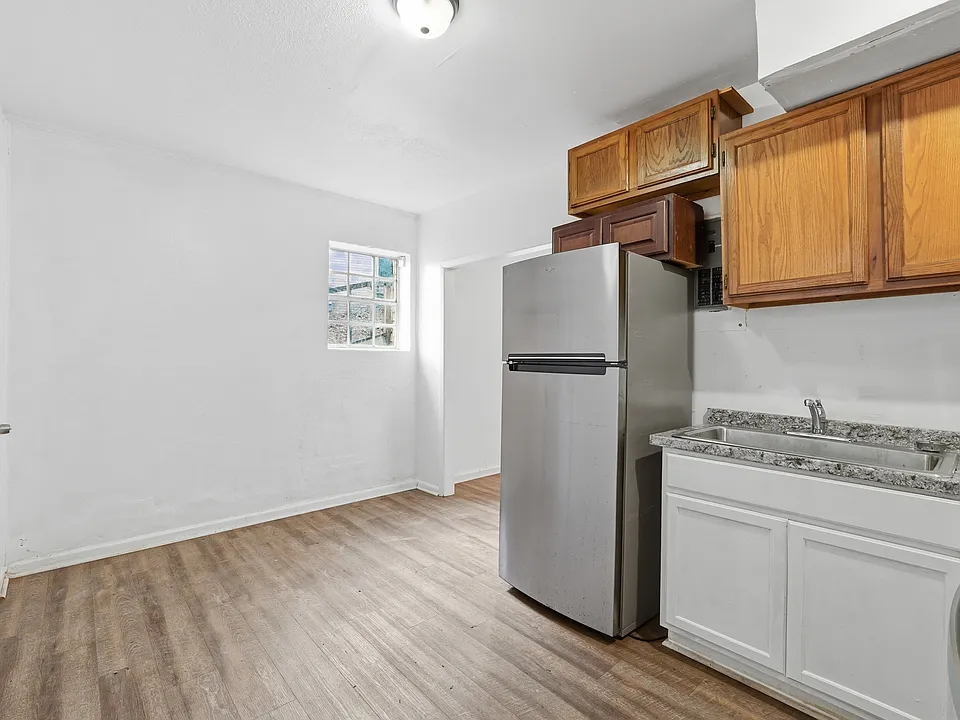 The lower level features a separate studio-style suite with its own full bathroom, kitchen, and private entrance ideal for a guest suite, home office, or bonus living space.