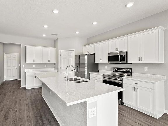 Your beautiful, new kitchen includes a counter-height island, walk-in pantry, and ample space - Aubr