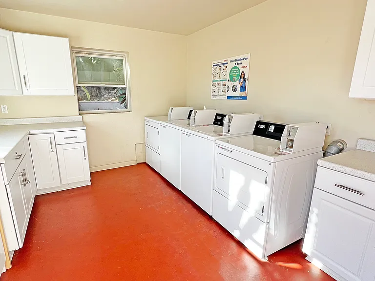 Laundry room with Smart Pay machines and plenty of counter space. No quarters needed.