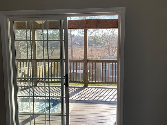 Living room leads to screened porch.