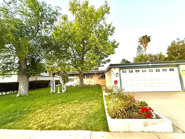 Charming front yard featuring a delightful swing, perfect for relaxing evenings or fun playdates with kids and pets. A cozy outdoor space designed for both enjoyment and everyday moments."