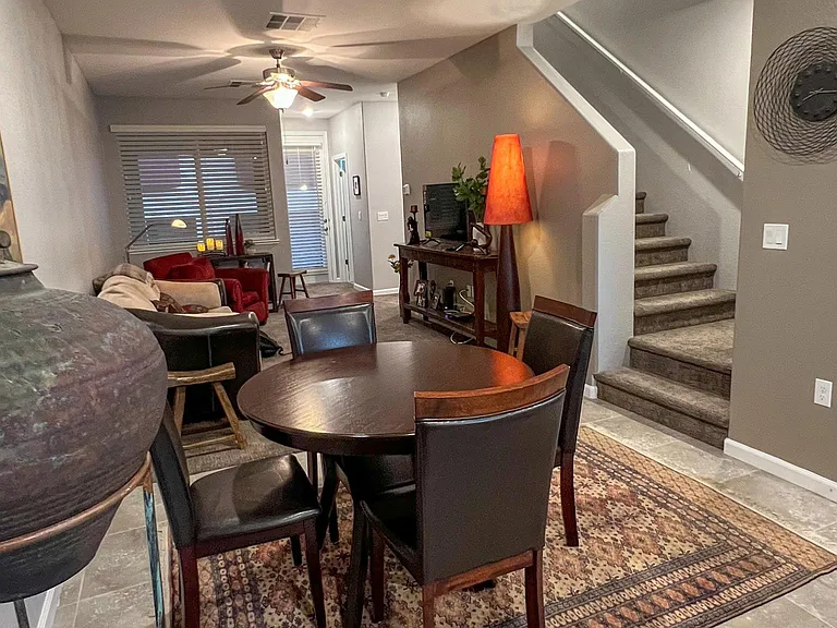 Living room. Door to balcony. Stairs to two bedroom suites.