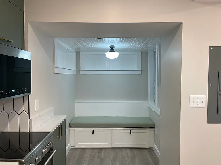 Dining nook with windows, built-in seating and bookcases.