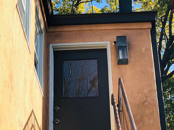 The front door up the stairs above a chiropractic business offers no common walls and off street parking.